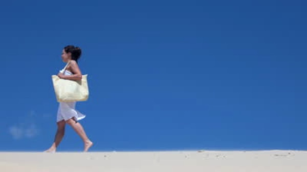 stock-footage-beautiful-smiling-girl-in-white-dress-with-beach-bag