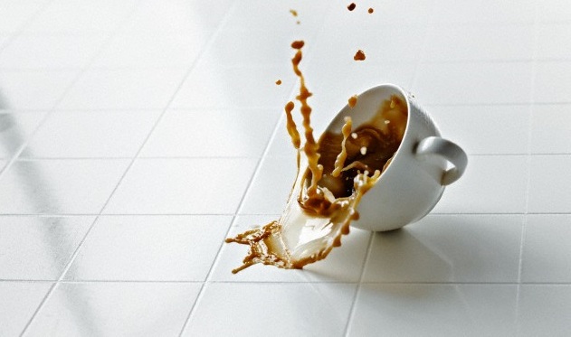Coffee cup in mid air with coffee spilling