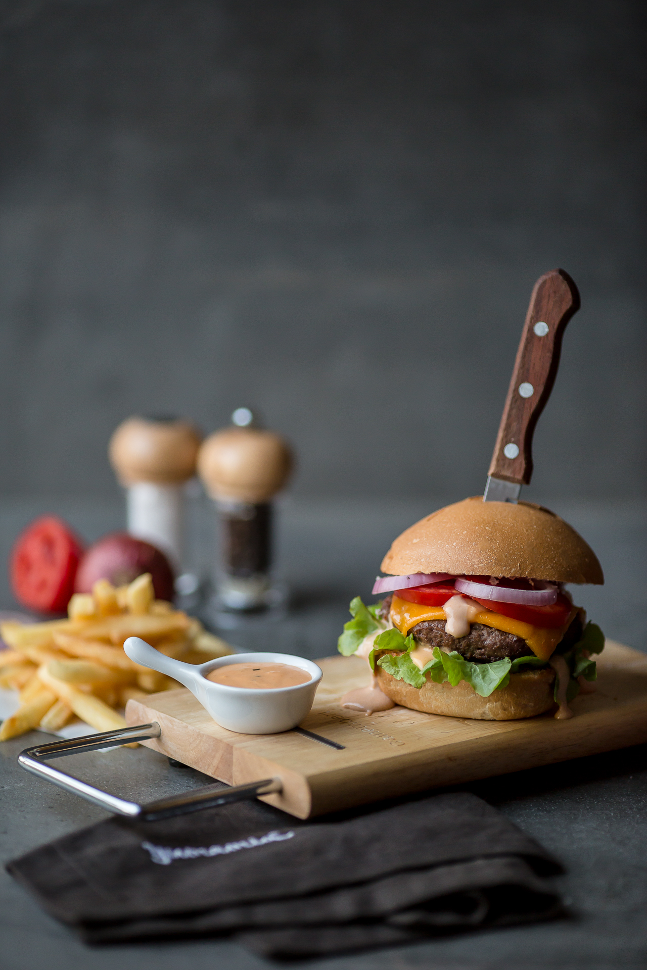 This grilled and succulent burger uses premium lean ground seasoned beef topped with melted cheddar cheese, onions, tomatoes, lettuce and a thousand islands sauce that is served in a buttered and grilled bun along with steak fries on the side. It's called the thousand islands burger.