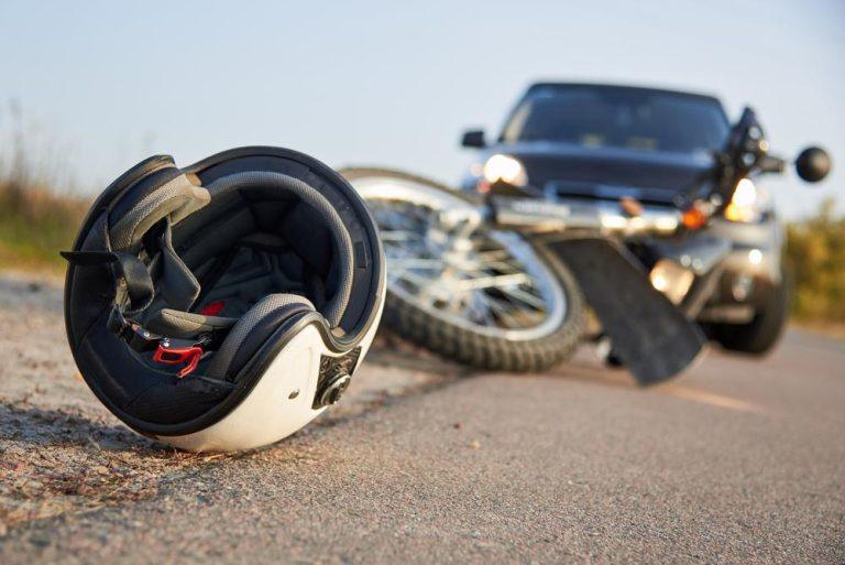 How Can Permanent Injuries Affect Motorcycle Accident Claims? Photo,Of,Car,,Helmet,And,Motorcycle,On,Road,,The,Concept